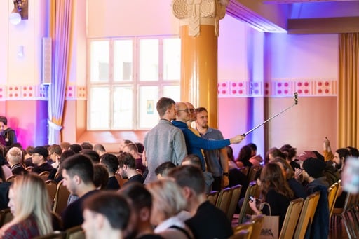 A group of people taking a selfie in the congress hall