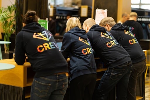 Four crew members at the registration desk