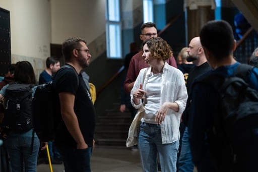 A woman and man having a discussion in the foyer