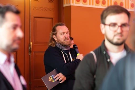 Antti Merilehto holding a microphone