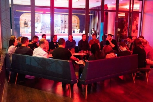 A big group of people having a discussion at the party