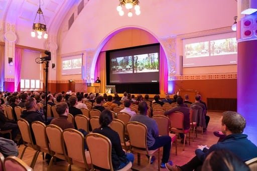 Adarsh Pandit presenting his talk, audience in foreground