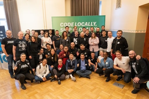 Group photo in front of the Shopify booth