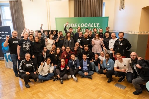 Group photo in front of the Shopify booth